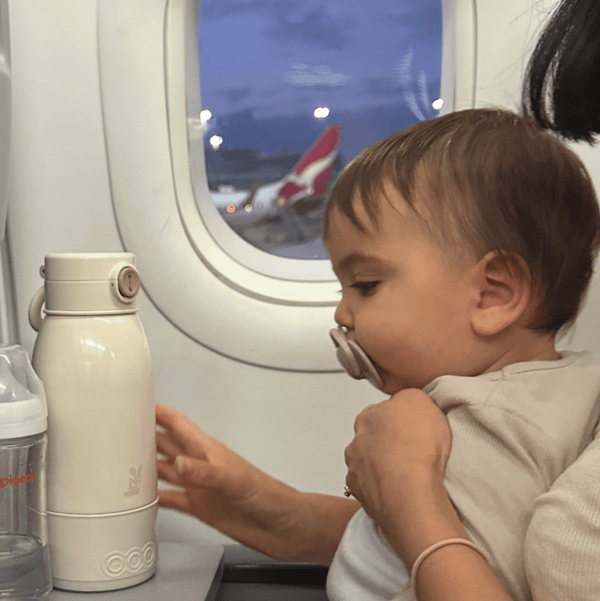 Child sitting on an airplane with a view of the wing through the window